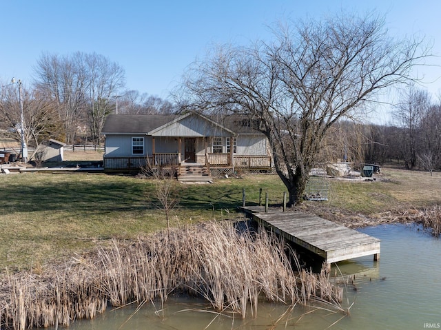 dock area featuring a deck with water view and a lawn