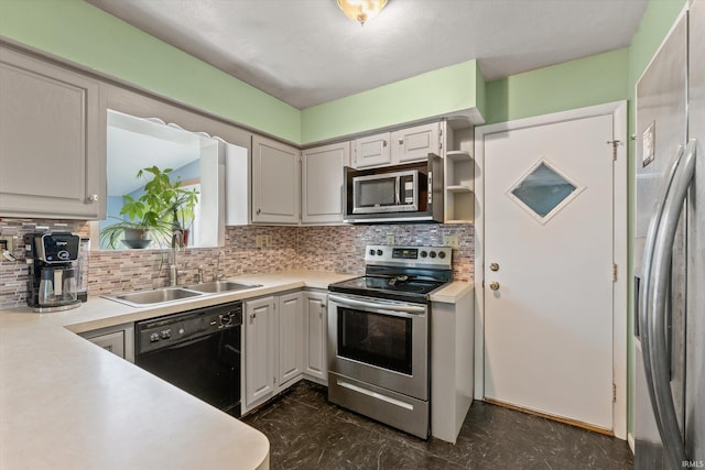 kitchen featuring a sink, stainless steel appliances, marble finish floor, and decorative backsplash