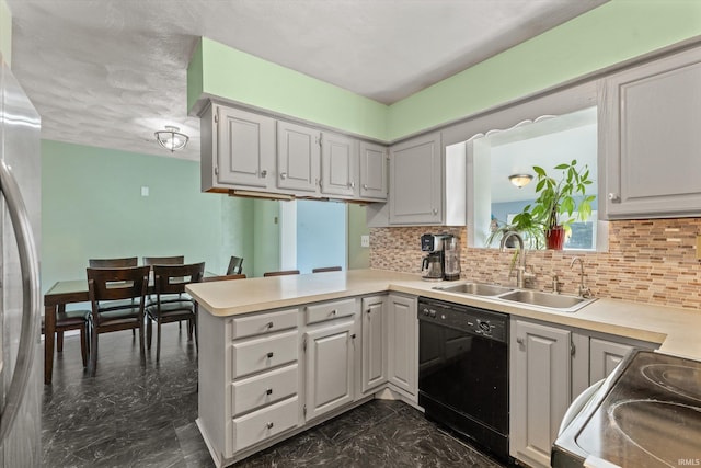 kitchen featuring a peninsula, freestanding refrigerator, black dishwasher, range with electric stovetop, and marble finish floor