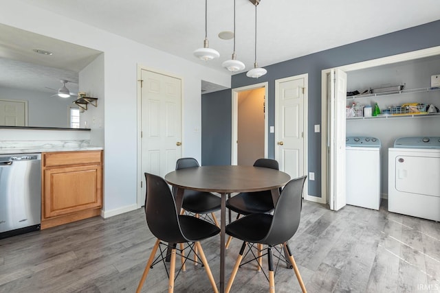 dining room with ceiling fan, baseboards, light wood-style flooring, and washer and clothes dryer