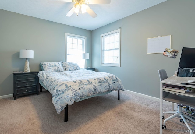 bedroom with light colored carpet, baseboards, and ceiling fan