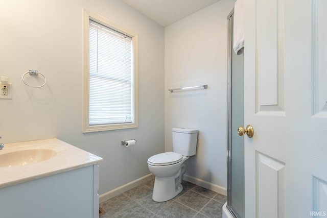 bathroom with tile patterned floors, a shower with shower door, toilet, baseboards, and vanity