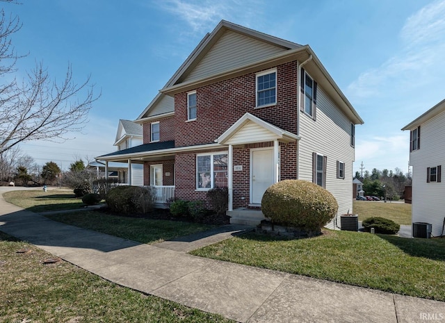 view of front of property featuring brick siding, central AC unit, a porch, and a front lawn