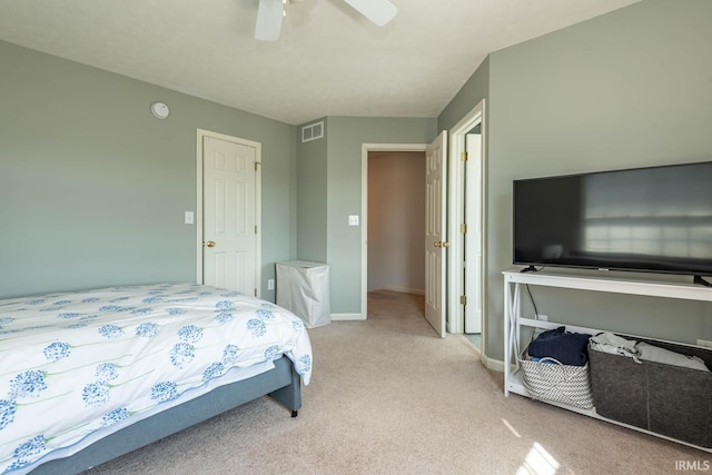 bedroom featuring visible vents, light colored carpet, a ceiling fan, and baseboards