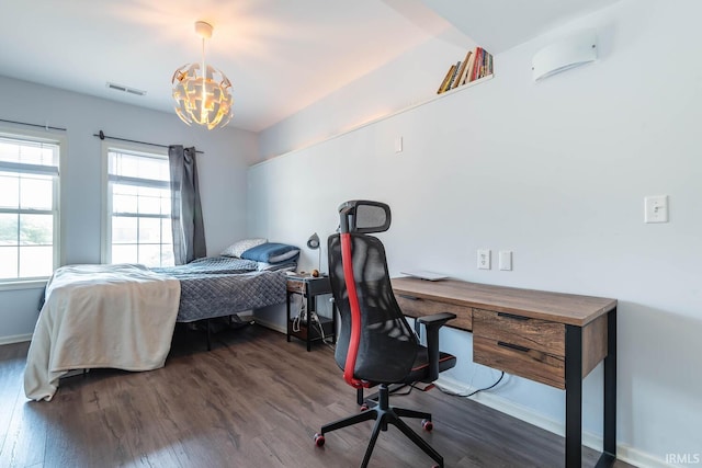 bedroom with dark wood-style floors, visible vents, baseboards, and a notable chandelier