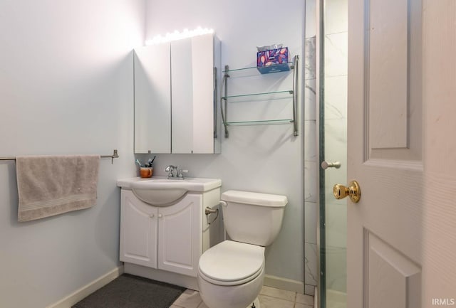 bathroom featuring baseboards, toilet, vanity, and tile patterned flooring