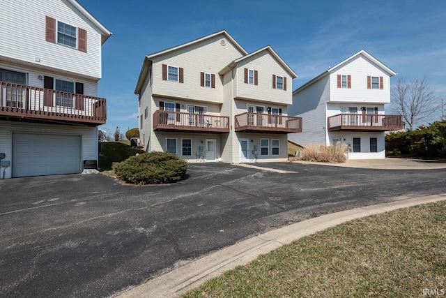 back of property featuring aphalt driveway