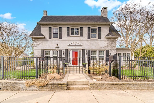 view of front of property with a fenced front yard and a chimney