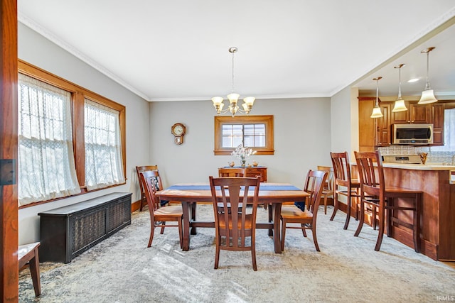 dining room featuring light carpet, a chandelier, and crown molding