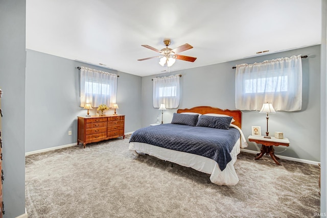 carpeted bedroom featuring baseboards and ceiling fan