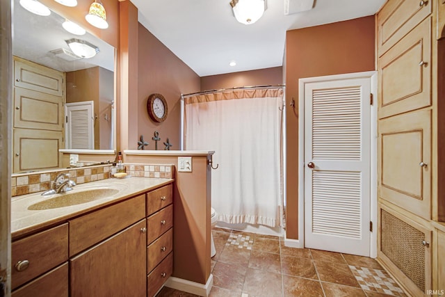 bathroom featuring tasteful backsplash, curtained shower, toilet, tile patterned floors, and vanity