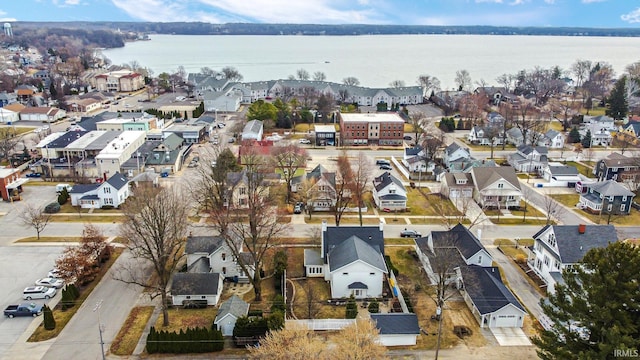 drone / aerial view featuring a residential view and a water view