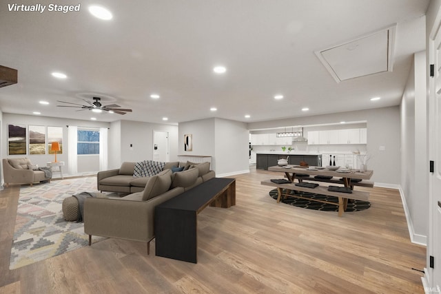 living area featuring recessed lighting, light wood-type flooring, and ceiling fan