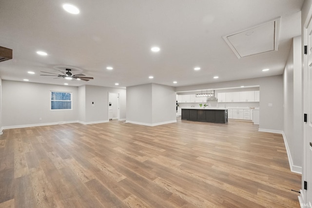 unfurnished living room featuring recessed lighting, baseboards, light wood-style floors, and ceiling fan