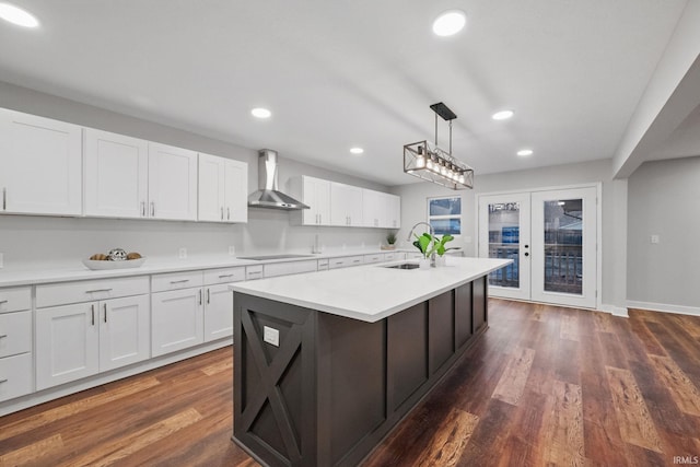 kitchen featuring dark wood-style floors, white cabinetry, recessed lighting, wall chimney exhaust hood, and light countertops