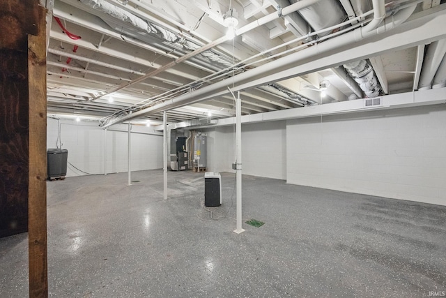 unfinished basement featuring visible vents and gas water heater