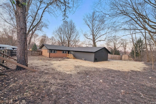 rear view of house featuring fence