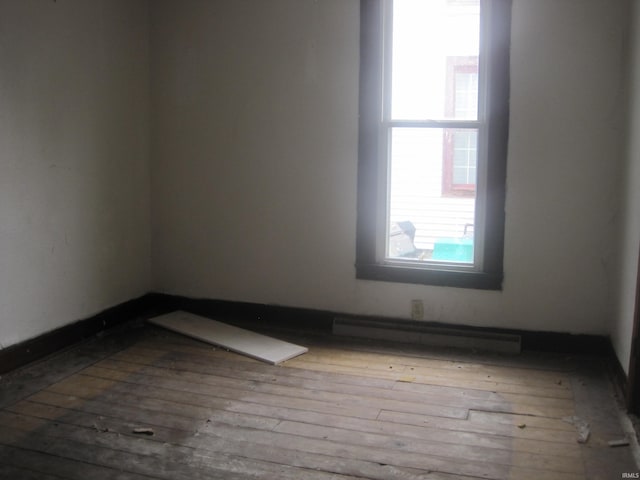 unfurnished room with hardwood / wood-style flooring