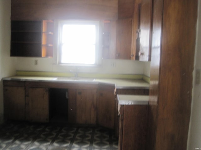 kitchen featuring light countertops and brown cabinets