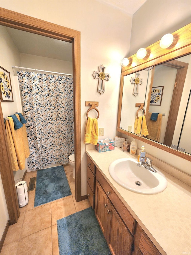 bathroom featuring tile patterned floors, visible vents, toilet, a shower with shower curtain, and vanity