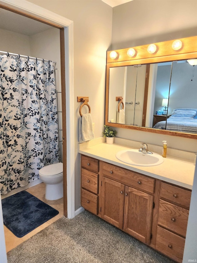 bathroom featuring vanity, curtained shower, and toilet