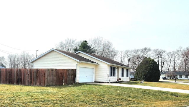 ranch-style house with a front yard, fence, and a garage