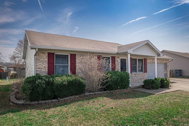 ranch-style home featuring a front yard, driveway, a shingled roof, a garage, and brick siding