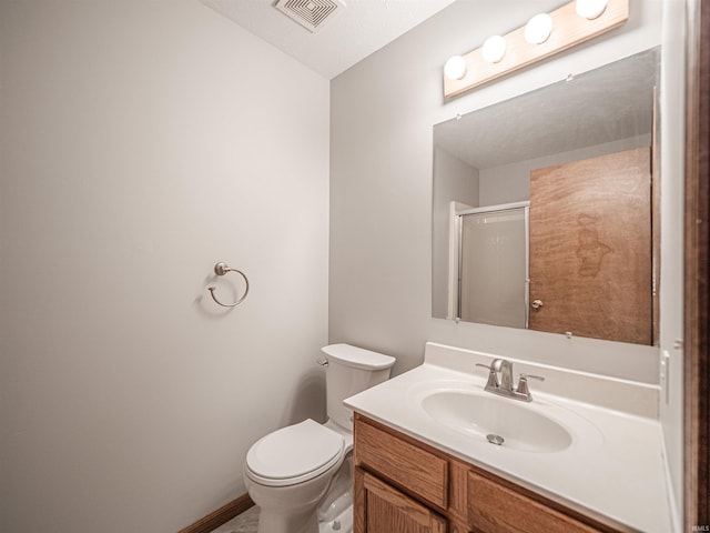 bathroom with visible vents, baseboards, toilet, an enclosed shower, and vanity