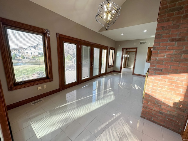 interior space featuring visible vents, an inviting chandelier, and baseboards