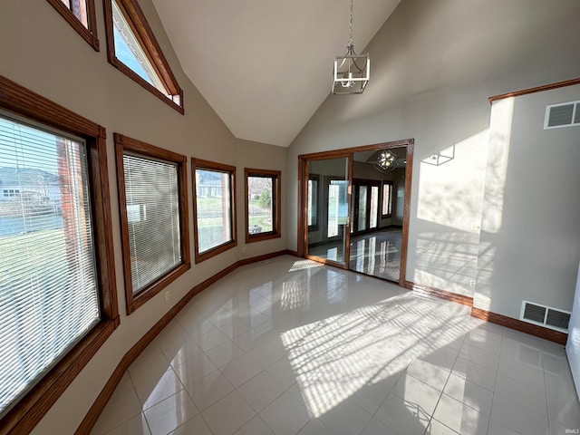 interior space featuring tile patterned floors, baseboards, visible vents, and a chandelier