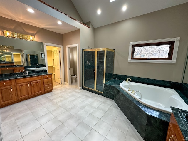 full bathroom with vanity, lofted ceiling, a stall shower, a garden tub, and toilet