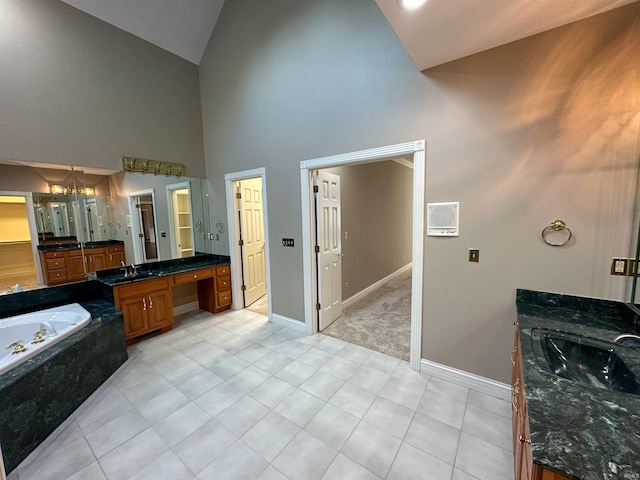 full bathroom with baseboards, a garden tub, vanity, and tile patterned flooring