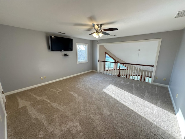 spare room featuring visible vents, baseboards, carpet, and ceiling fan