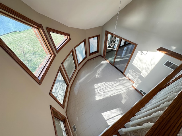 interior space with visible vents and a high ceiling