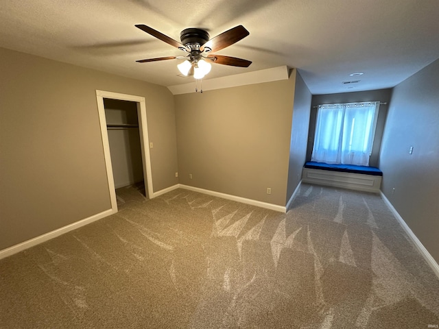 unfurnished bedroom featuring baseboards, carpet floors, a textured ceiling, and ceiling fan