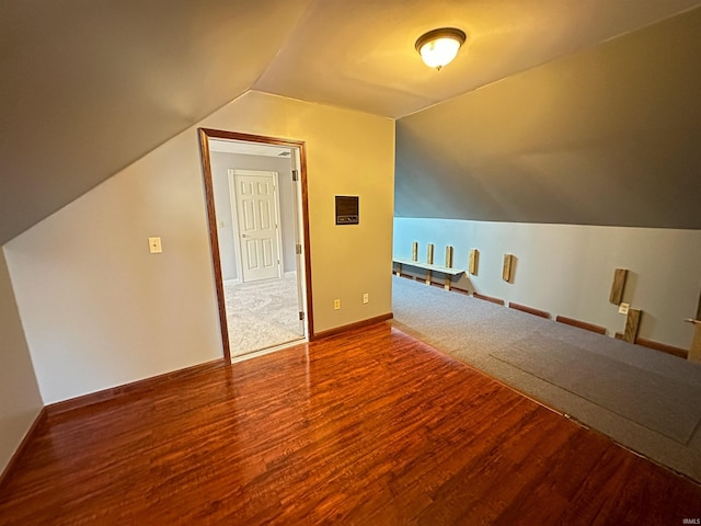 bonus room featuring vaulted ceiling, wood finished floors, and baseboards