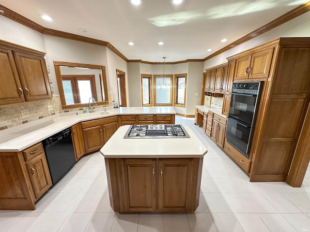 kitchen featuring a sink, black appliances, a peninsula, and brown cabinetry