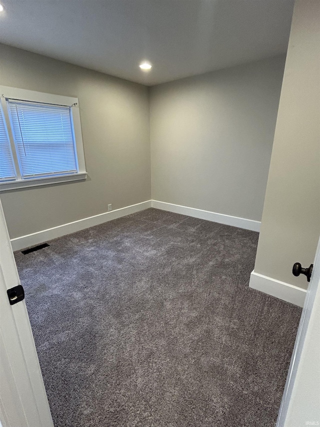 unfurnished room with recessed lighting, visible vents, baseboards, and dark carpet