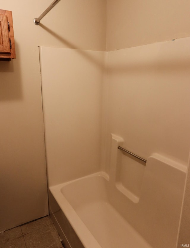 bathroom with tile patterned flooring, a bath, and walk in shower