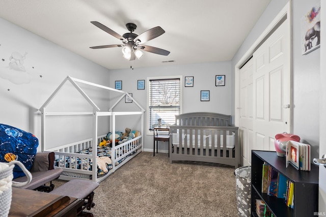 bedroom featuring visible vents, baseboards, carpet, a closet, and a ceiling fan