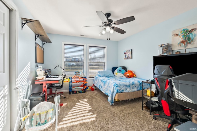 carpeted bedroom with visible vents and a ceiling fan