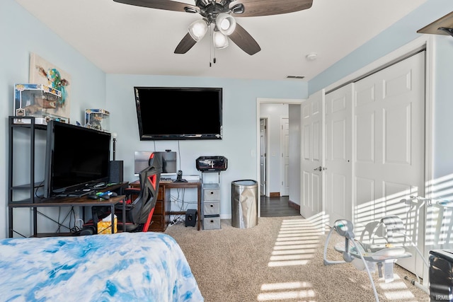 bedroom with visible vents, baseboards, carpet floors, a closet, and a ceiling fan