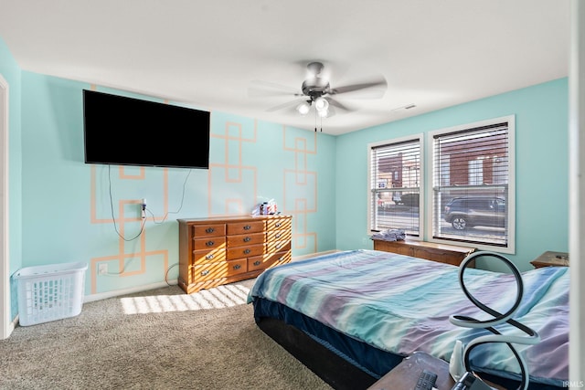 carpeted bedroom featuring a ceiling fan, baseboards, and visible vents