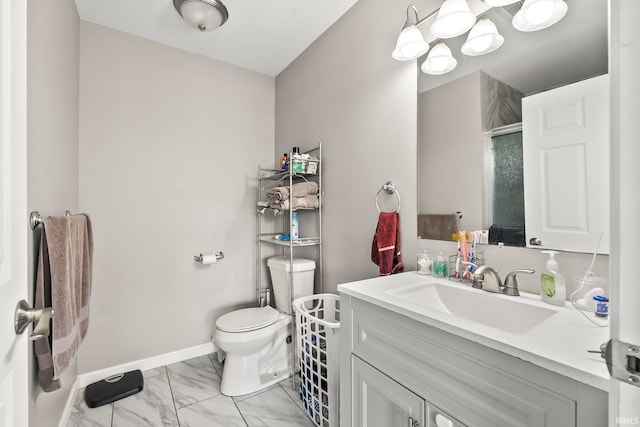 bathroom featuring toilet, marble finish floor, baseboards, walk in shower, and vanity