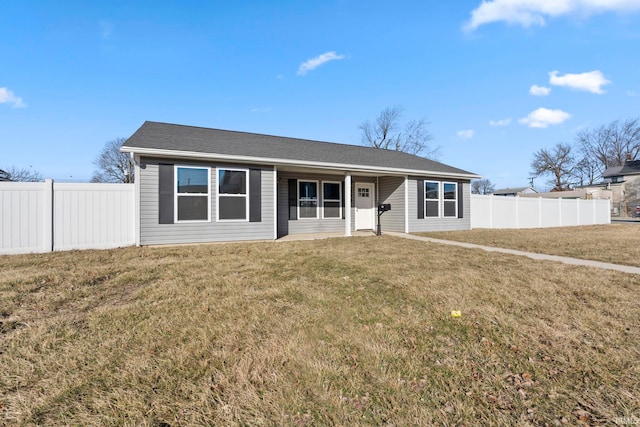 ranch-style house featuring a front lawn, fence, and roof with shingles