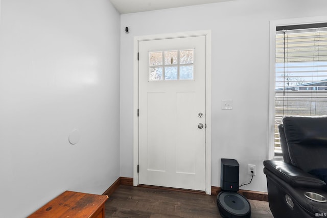 foyer entrance with wood finished floors and baseboards