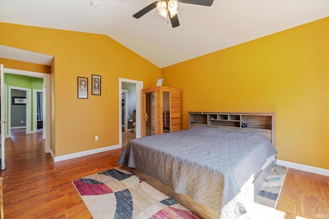 bedroom featuring ceiling fan, baseboards, lofted ceiling, and wood finished floors