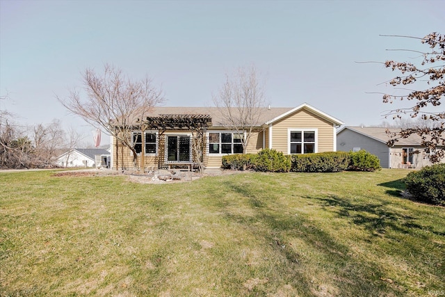 rear view of house with a pergola and a yard