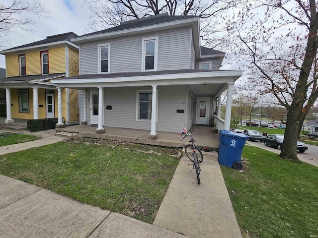 view of front of house featuring covered porch and a front yard