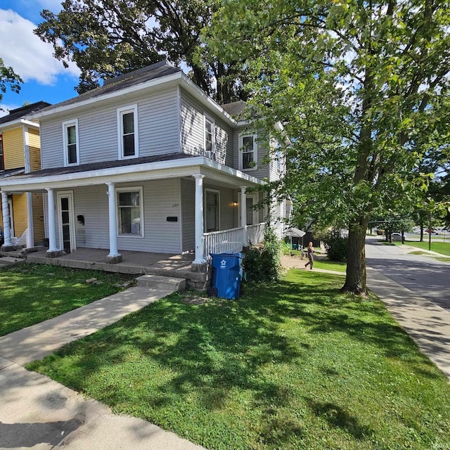 farmhouse inspired home featuring a porch and a front yard